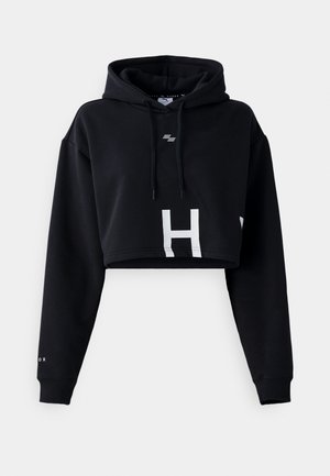 Black cropped hoodie made of soft fabric, featuring a large white "H" on the front and a drawstring hood with contrasting accents.