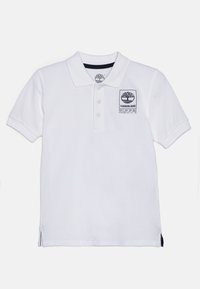 Maglietta polo bianca in cotone con colletto, apertura con tre bottoni e una patch nera con il logo Timberland sul petto. Fessure laterali all'orlo.