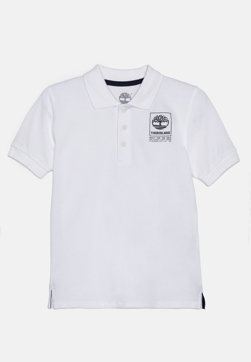 Maglietta polo bianca in cotone con colletto, apertura con tre bottoni e una patch nera con il logo Timberland sul petto. Fessure laterali all'orlo.