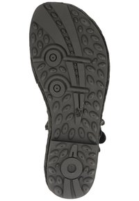 Suola di scarpa nera con superficie testurizzata che presenta motivi circolari e ovali. Due dettagli circolari sono visibili, migliorando la presa e il supporto.