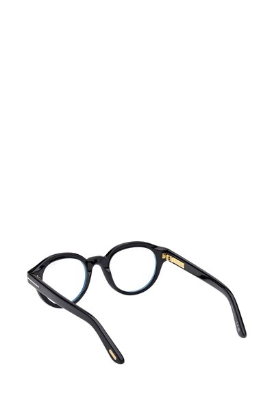 Occhiali con montatura rotonda nera e finitura lucida. Presentano lenti con tinta blu e dettagli dorati sulle aste. Texture liscia e design moderno.