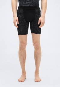 Μαύρο σορτς με υφασμάτινη υφή, εφαρμοστή γραμμή, ελαστική μέση και ξεχωριστό σχεδιαστικό ύφασμα.