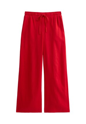 Pantalons larges rouges au design décontracté, dotés d'une taille élastique et d'un cordon de serrage. Fabriqués en tissu léger avec une texture lisse.