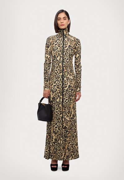 Leopard print maxi dress with a high collar and full zip, made from smooth fabric. Includes a black handbag and platform shoes.