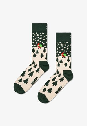 Calze al ginocchio con una parte superiore e una punta verde, un corpo bianco decorato con alberi verdi e un gnome, e la parola "HAPPY" sulla pianta.