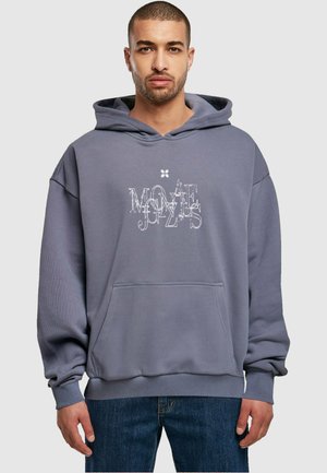 Gray oversized hoodie with a front pocket; features a white graphic print that reads “MOVE,” with ribbed cuffs and hem. Soft texture.
