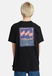 Black t-shirt featuring a colorful graphic on the back, with wave patterns in pink and blue, framed by a decorative border.