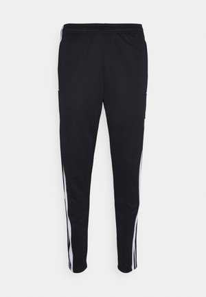 Black athletic pants with a relaxed fit, featuring white side stripes, a drawstring waist, and two side pockets. Made from soft fabric.