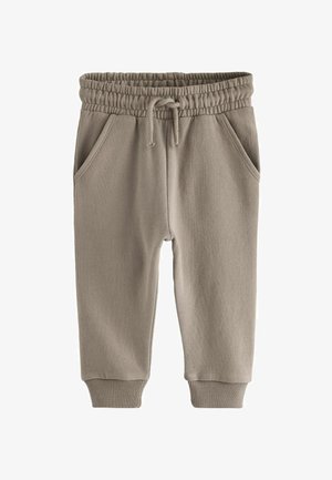 Ljusbeige svettbyxor gjorda av mjukt tyg, med ett elastiskt midjeband och snörning, två sidofickor och ribbade fållar.