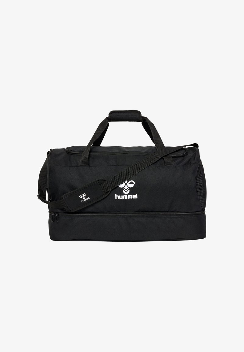 Sac de sport Hummel noir avec bandoulière réglable, poignées supérieures et compartiment séparé zippé en bas.