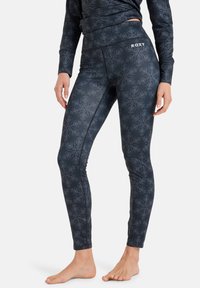 Wysokie legginsy sportowe w kolorze granatowym z geometrycznym wzorem na całej powierzchni. Materiał elastyczny z płaskimi szwami i logo Roxy na pasie.