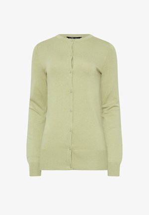 Vihreä jakku, joka on valmistettu pehmeästä neuloksesta. Ominaisuuksiin kuuluu pyöreä kaula-aukko, nappikiinnitys edessä, pitkät hihat ja ribbineulottu hihansuu.