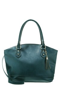 Sac à main en cuir vert sarcelle foncé avec deux poignées supérieures, bandoulière amovible et un pendentif pompon suspendu sur le côté droit.