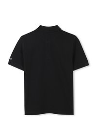 Black polo shirt with a collar and short sleeves. Smooth texture, classic fit, featuring minimal branding on the left sleeve.
