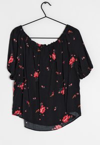 Black off-the-shoulder blouse with red floral patterns, gathered neckline, short puff sleeves, and curved hemline. Soft fabric texture.