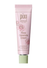 Lys rosa tube med Pixi Rose Ceramide Cream, som har rosenillustrasjoner, grønn kork og hvit tekst på en glatt overflate. 50 ml kapasitet.