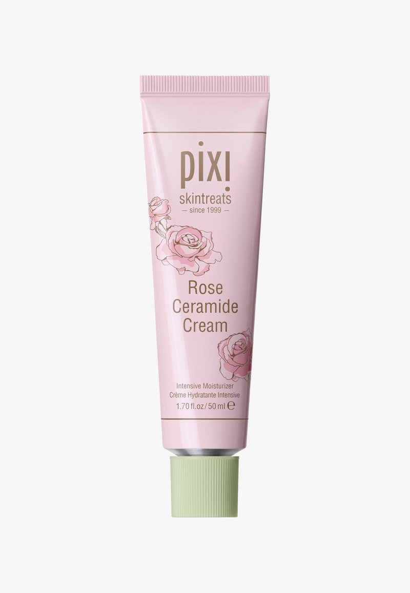 Lys rosa tube med Pixi Rose Ceramide Cream, som har rosenillustrasjoner, grønn kork og hvit tekst på en glatt overflate. 50 ml kapasitet.
