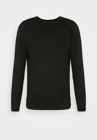 T-shirt noir à manches longues avec col rond et coupe ajustée, présenté sur un fond clair uni.