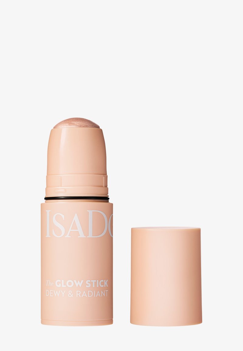Enlumineur IsaDora Glow Stick dans un flacon cylindrique beige avec un capuchon transparent, présentant un produit de maquillage éclatant et radieux.