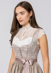 Sleeveless dirndl dress featuring a light gray patterned bodice with white lace accents and a satin ribbon at the waist. White lace high collar.