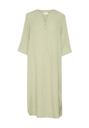Light green linen dress with a V-neck, three-quarter sleeves, button detail, and side slits for ease of movement.