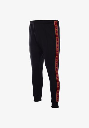 Zwarte joggerbroek met elastische tailleband en rode zijstrepen met herhaalde gele cirkelvormige logopatronen.