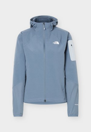 Φωτεινό γαλάζιο υφασμάτινο μπουφάν με φερμουάρ και κουκούλα, λευκή τσέπη με φερμουάρ στο αριστερό μανίκι και το λογότυπο The North Face στο στήθος.