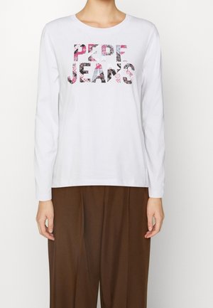 Weißes Langarm-T-Shirt mit einem mehrfarbigen "PEPE JEANS" Grafikdesign. Rundhalsausschnitt und lockere Passform, kombiniert mit braunen, weit geschnittenen Hosen.