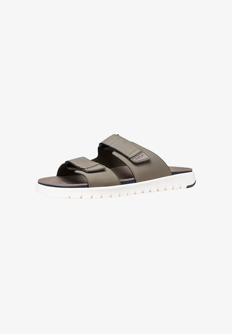 Sandale slide grise pour homme avec deux brides ajustables et semelle blanche rembourrée, conçue pour un usage décontracté.