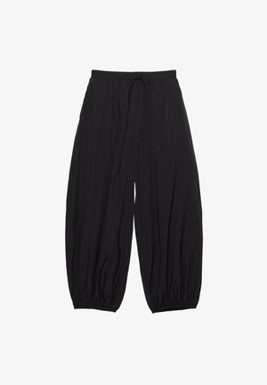 Pantalon noir ample avec une ceinture élastique et un cordon de serrage. Tissu texturé avec des poignets effilés à la cheville.