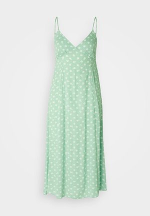 Light green dress made of a soft fabric, featuring adjustable spaghetti straps and a floral pattern with white flowers. A-line silhouette.