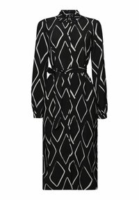 Robe-chemise noire à manches longues avec motif losange blanc, boutonnage devant, col et ceinture nouée à la taille.