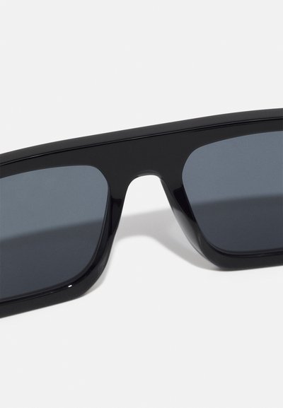 Black rectangular sunglasses with dark lenses, featuring a smooth, glossy plastic frame and sharp angles for a contemporary design.