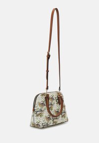 Shoulder bag with a patterned exterior featuring animal and foliage motifs, made from synthetic fabric, accented with brown leather handles.