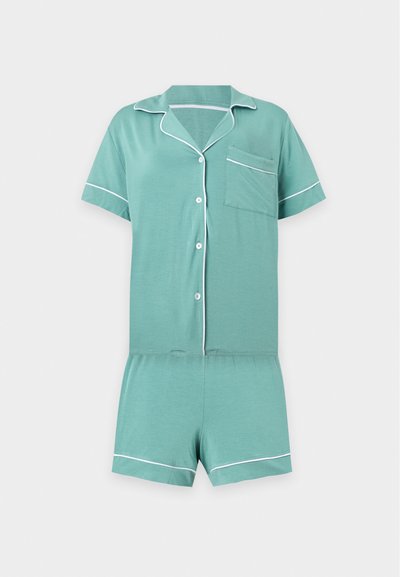 Ensemble de pyjama vert à manches courtes avec passepoil blanc, chemise boutonnée avec poche poitrine et short assorti sur fond uni.