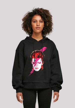 Black hoodie featuring a graphic of a face with red hair and a pink lightning bolt design. Loose fit with a drawstring hood.