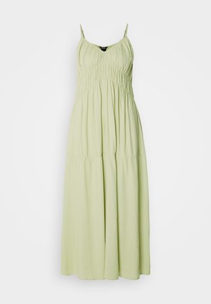 Light green long dress with thin straps, gathered bodice, and flowing skirt. Made from soft fabric with a smooth texture.