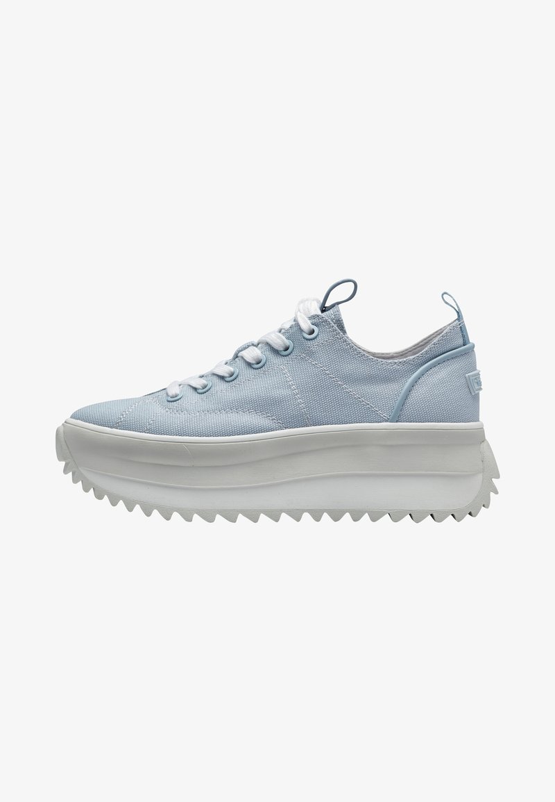 Blue canvas sneakers with a thick white, serrated sole and white laces. Features a tab at the back for easy wear and a textured upper.