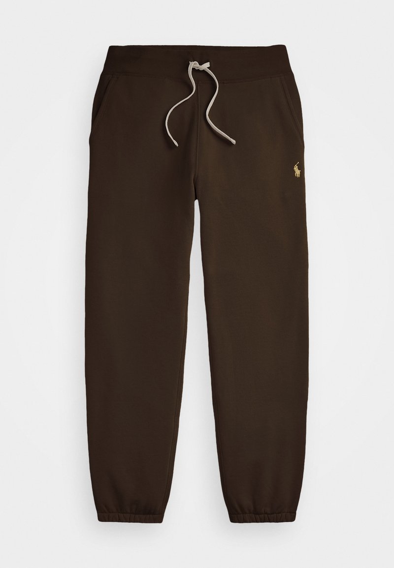 Brune sweatpants lavet af blødt stof med en elastisk talje, justerbar snor og ribbede ankler. Har et guld logo på siden.