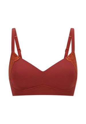 Sujetador inalámbrico de color óxido con tirantes ajustables y detalles de encaje en los laterales superiores, presentado sobre un fondo blanco.