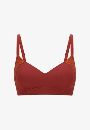 Sujetador inalámbrico de color óxido con tirantes ajustables y detalles de encaje en los laterales superiores, presentado sobre un fondo blanco.