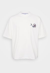 White cotton T-shirt with short sleeves, featuring a printed design of a fish and text on the left chest near the neckline.