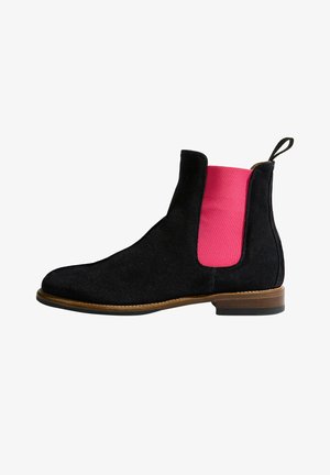 Sorte ruskind Chelsea støvler med en lys pink elastisk sidepanel, rund tå, brun lædersål og en løkke bagpå.