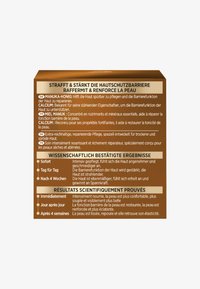 Brunt rektangulärt förpackning med flerspråkig text. Viktiga detaljer om ingredienser som Manukahonung och kalcium framhävs. Enkelt design.