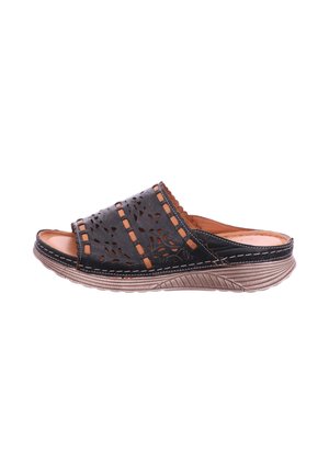 Black leather slip-on sandal with decorative cutouts, tan stitching, and a textured beige sole viewed from the side.