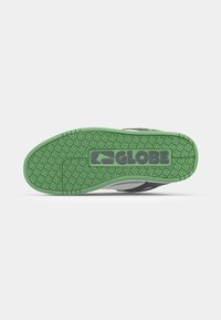 Rubber outsole with a textured grip; green color with a logo. Gray and black upper portion with curved design and contrasting accents.