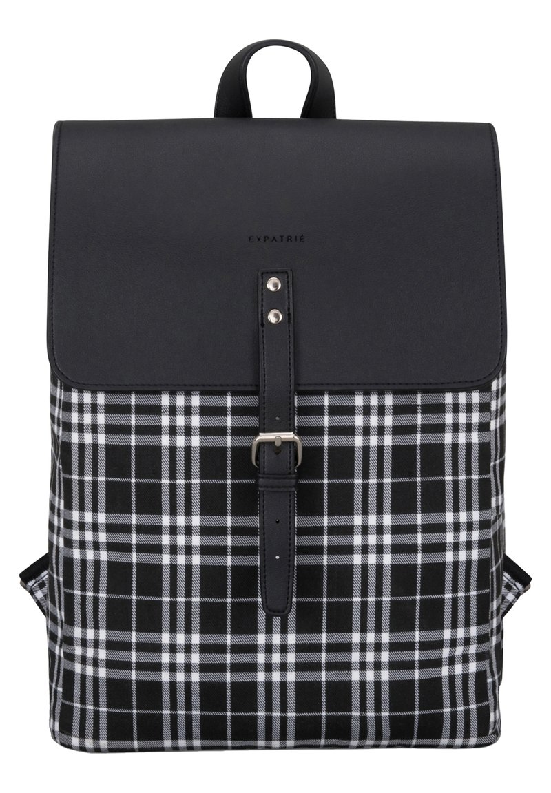 Black and white plaid fabric backpack with a leather flap, buckle closure, and a top handle. Features adjustable shoulder straps.