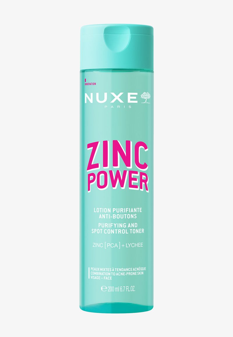 Transparent flaska med en turkos kork. Innehåller en toner märkt "ZINC POWER" i fet rosa och vit text. 200 ml kapacitet.