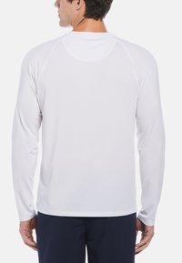 Long-sleeve, white athletic shirt with a smooth texture, raglan sleeves, and a round neck. Features a lightweight, breathable design.