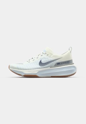 Nike Invincible Run 3 shoes feature a white and light blue upper with a textured knit, a cushioned sole, and a rubber outsole for traction.